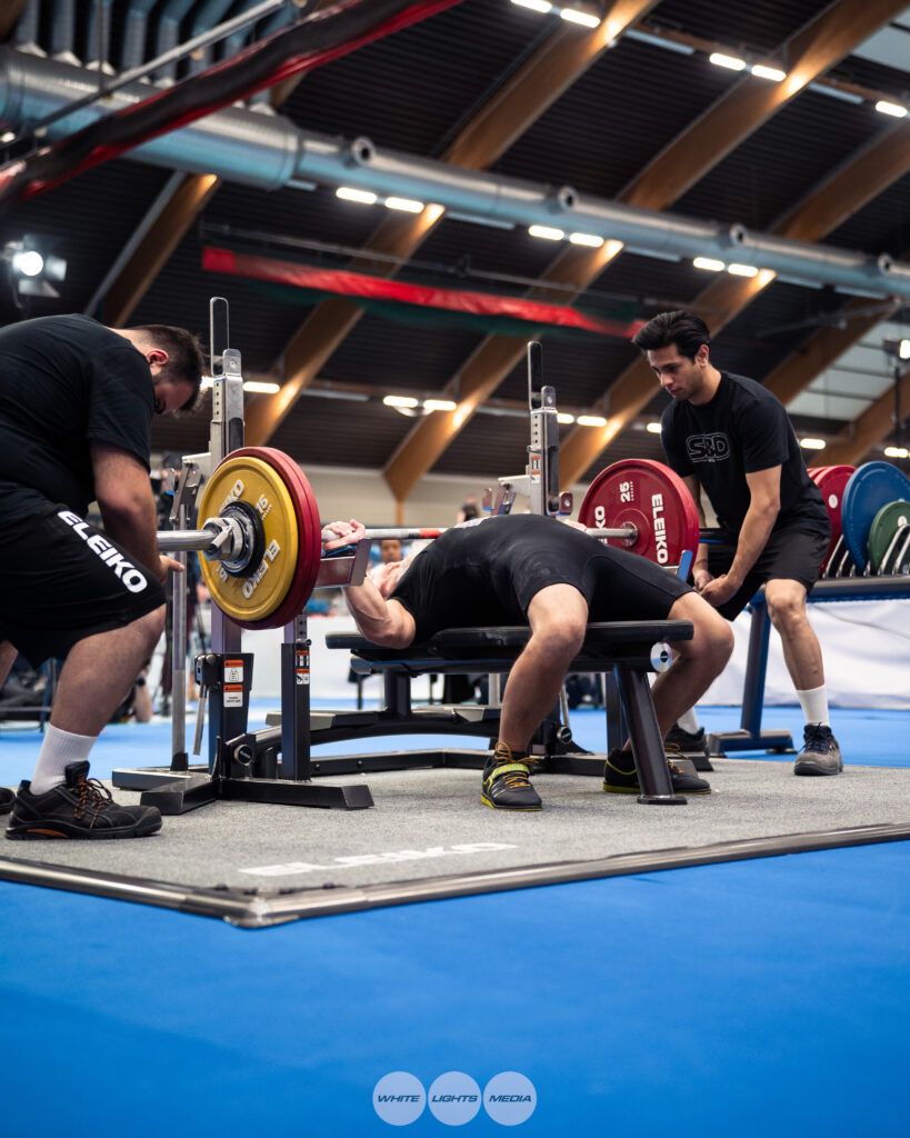 Dr. Damian Fronzaglia performs a bench press at the 2025 IPF World Championships in Drammen, Norway