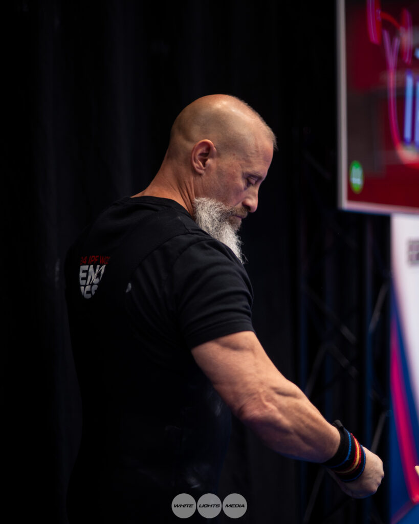 Dr. Damian Fronzaglia adjusts his wrist wraps before competing at the 2025 IPF World Bench Press Championships in Drammen, Norway
